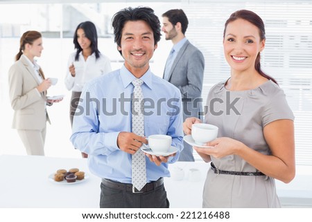 Business people enjoying their drinks while chatting