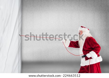 Santa pulls something with a rope against grey wall