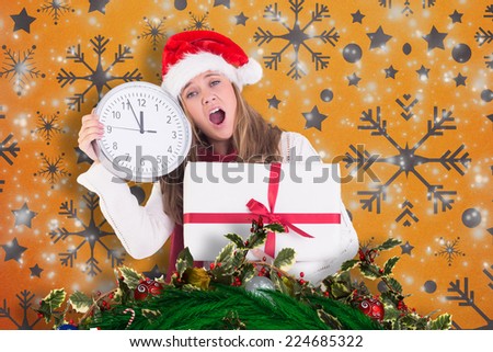 Festive blonde showing a clock and gift against snowflake wallpaper pattern