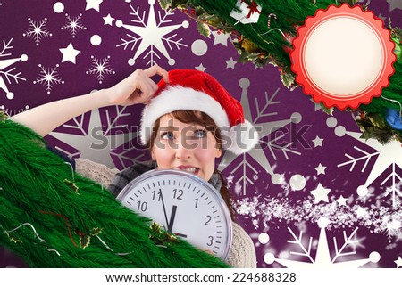 Woman holding a large clock against snowflake wallpaper pattern