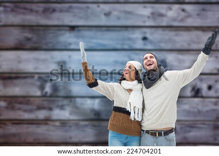 Young winter couple against blurry wooden planks