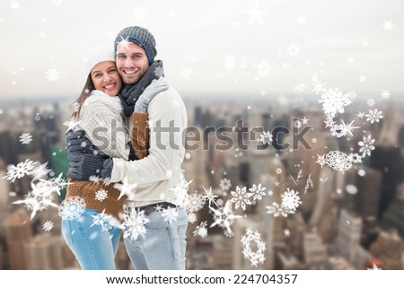 Young winter couple against city skyline