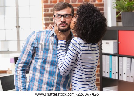 Close up of young woman kissing man in the office