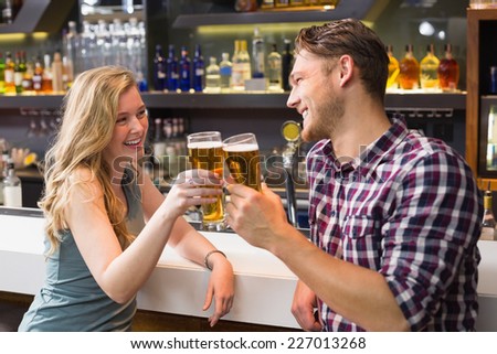 Young couple having a drink together at the bar
