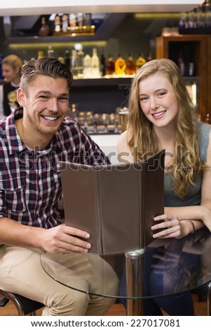 Young couple discussing the menu at the bar