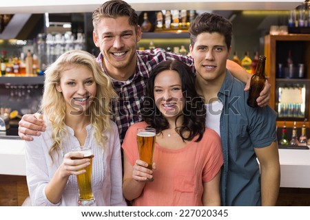 Young friends having a drink together at the bar