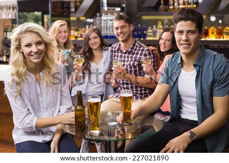 Young friends having a drink together at the bar