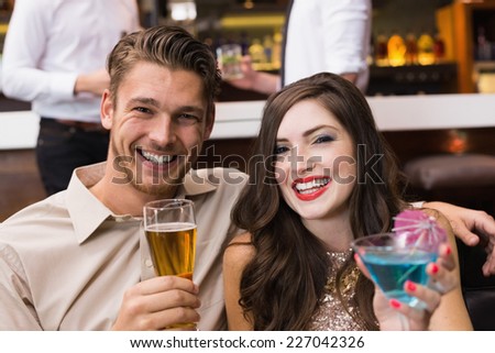Happy couple having a drink together at the bar