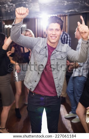 Stylish man smiling and dancing at the bar