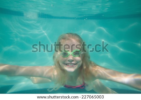 Cute kid posing underwater in pool at the leisure center
