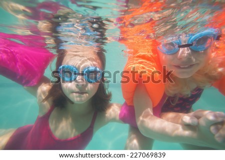 Cute kids posing underwater in pool at the leisure center