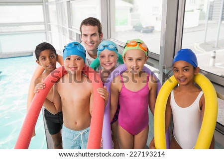 Swimming coach with his students poolside at the leisure center