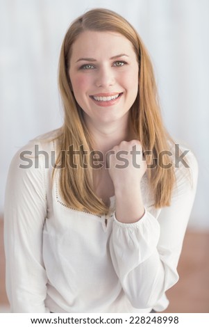 Happy woman celebrating success with her hand at home in the living room