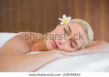 Close up of a beautiful young woman lying on massage table at spa center