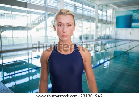 Portrait of a female swimmer by the pool at leisure center