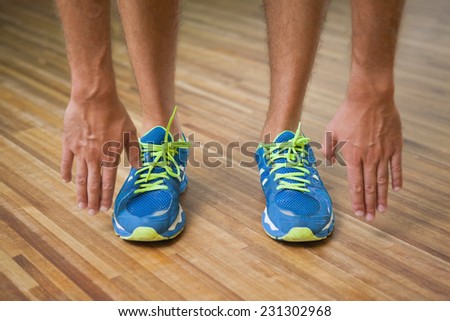 Close up low section of a man in sports shoes in fitness studio