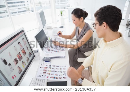 Creative team working at desk in creative office