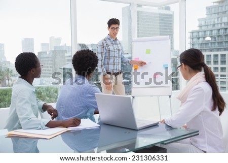 Casual business team working together at desk in creative office