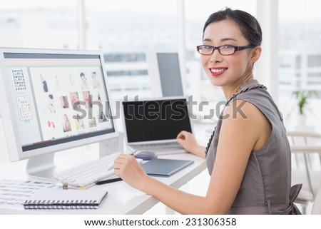Photo editor working at her desk in creative office
