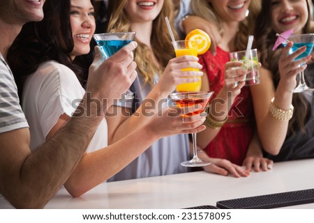 Happy friends having a drink together in a bar