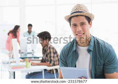 Young creative man using his tablet in creative office