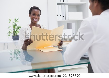 Smiling coworkers studying a document in the office