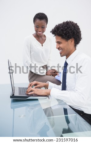 Smiling designer team using laptop in the office