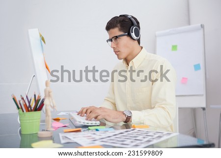Serious designer listening music and working in his office
