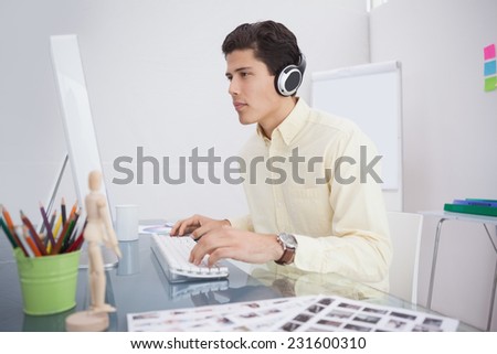 Designer working and listening music in his office