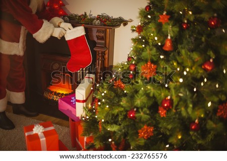 Father christmas stocking gifts at christmas eve at home in the living room