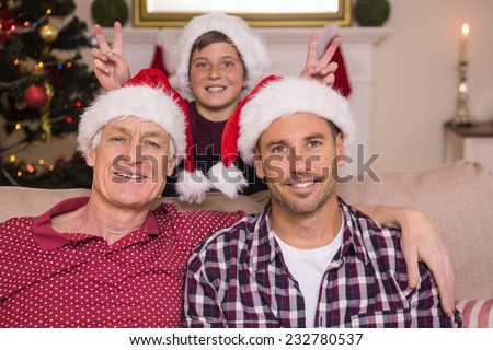 Son joking to his father and grandfather at home in the living room