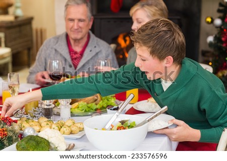 Extended family at the christmas dinner table at home in the living room