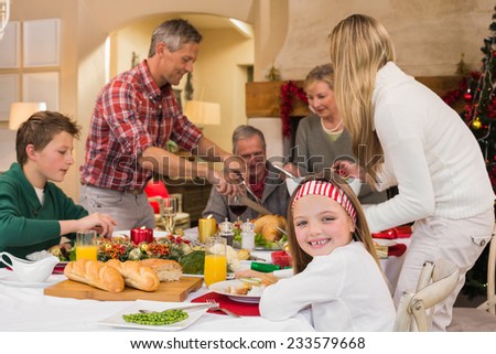 Three generation family having christmas dinner together at home in the living room