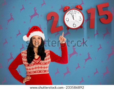Woman pointing in the air against blue and purple reindeer pattern