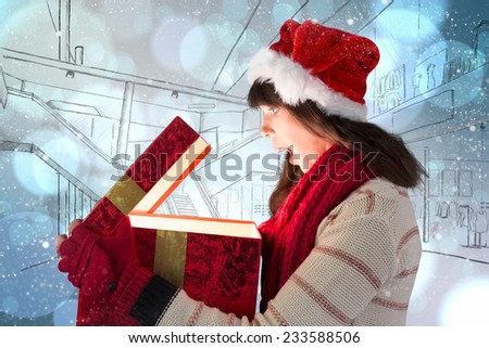 Festive brunette opening a glowing christmas gift against light glowing dots design pattern