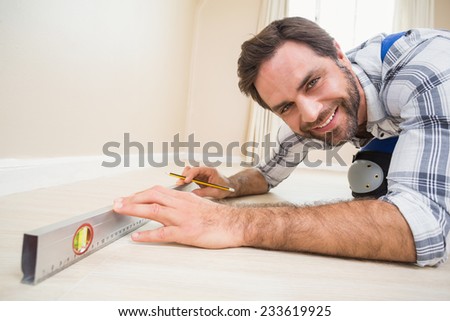 Construction worker using spirit level in a new house