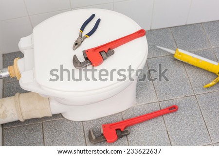Plumbing tools on the toilet in the bathroom