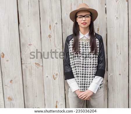 Pretty hipster looking at camera against bleached wooden planks