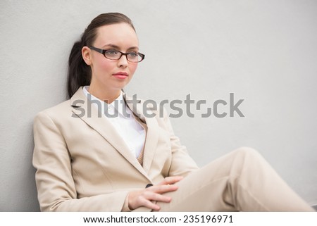 Young businesswoman sitting and thinking outside in the city