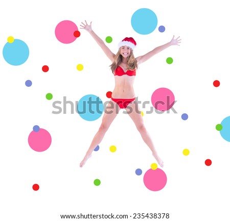Festive fit blonde in red bikini against dot pattern