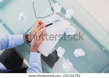 Businessman running out of ideas in his office