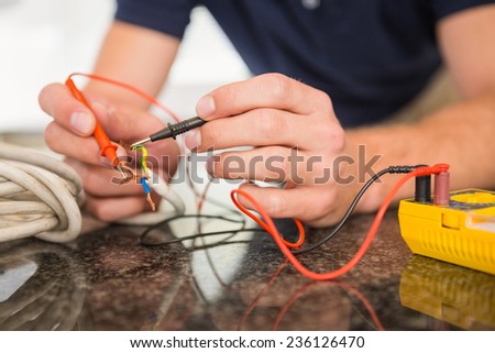 Construction worker working on cables in the kitchen