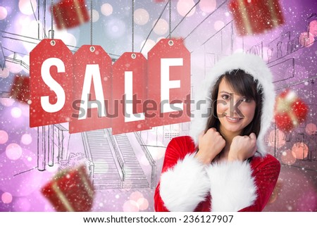 Cute brunette in santa claus smiling at camera against light glowing dots on purple