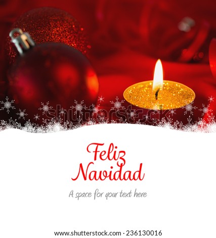 Feliz navidad against golden tea light candle with christmas decorations