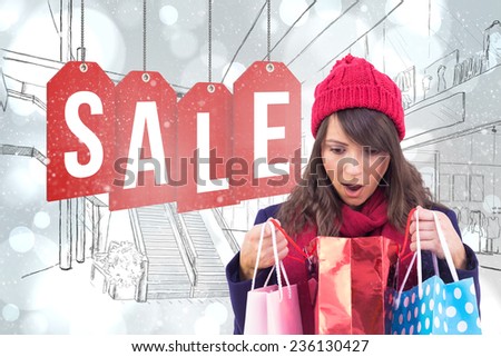 Shocked brunette opening gift bag against white glowing dots on grey