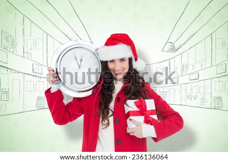 Festive brunette holding a clock and gift against snowflake wallpaper pattern