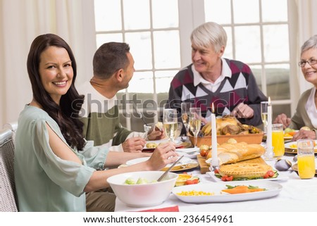 Smiling woman with her family during christmas dinner at home in the living room