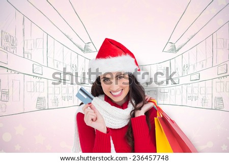 Excited brunette holding shopping bags and credit card against snowflake wallpaper pattern