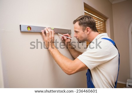 Construction worker using spirit level in a new house