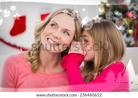Daughter telling her mother a christmas secret against christmas themed frame